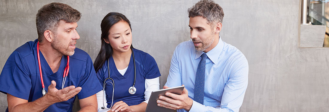 Man Talking to Two People in Scrubs | Virginia Mason Institute