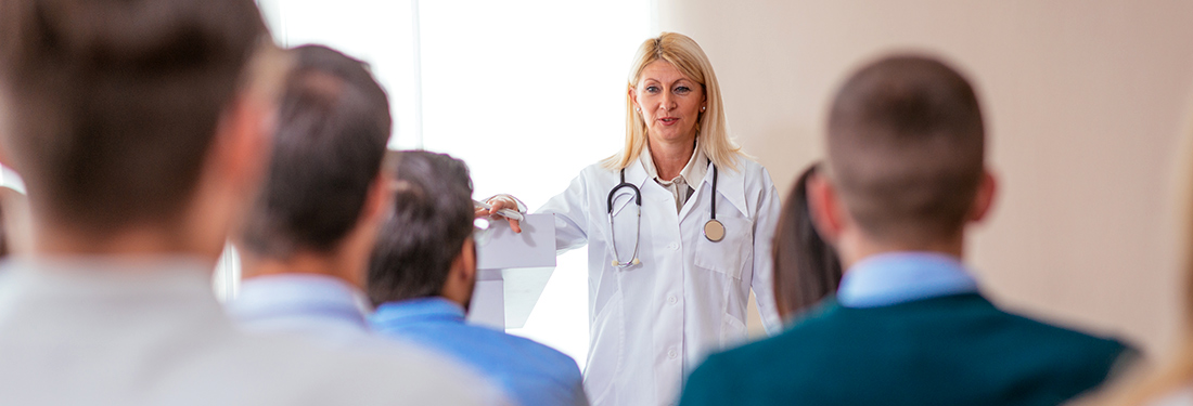 Doctor presenting to a group of healthcare professionals.