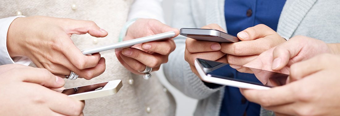 A group of people using their mobile phones together