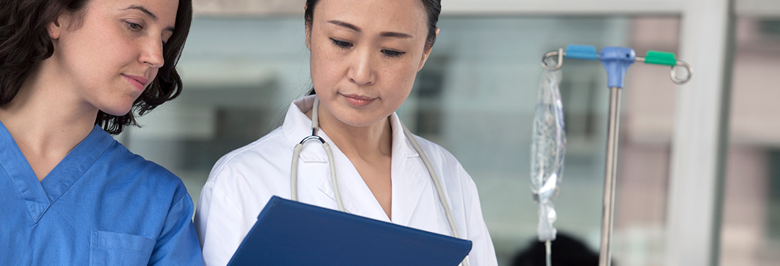 A doctor and nurse reviewing a document together.