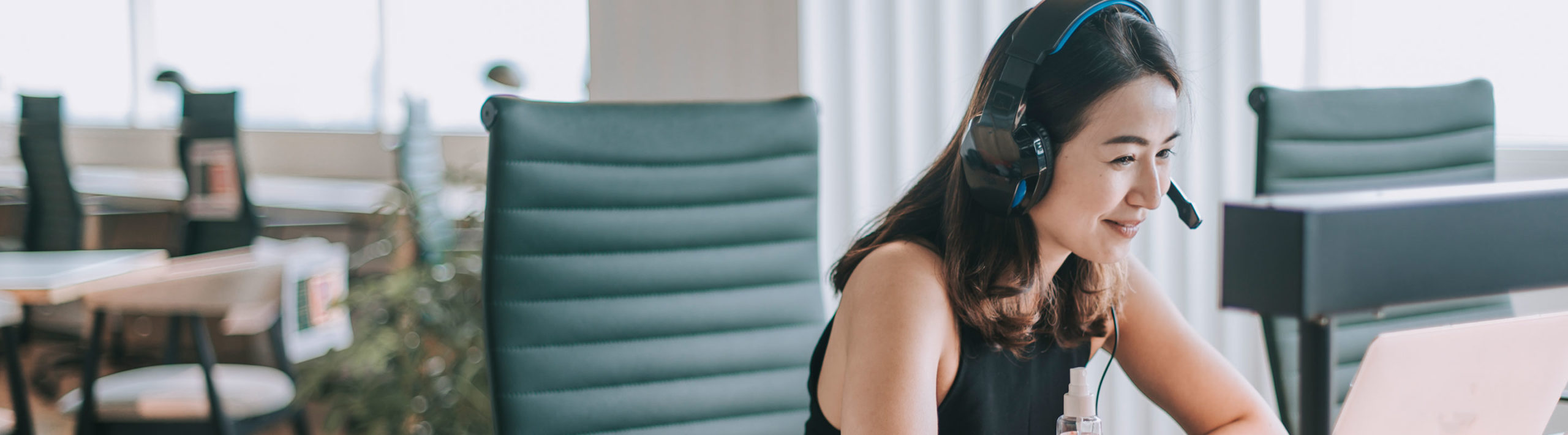 Woman wearing headphones on an online conference | Virginia Mason Institute