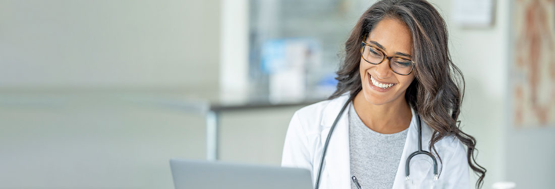 Female doctor in lab coat smiling | Virginia Mason Institute