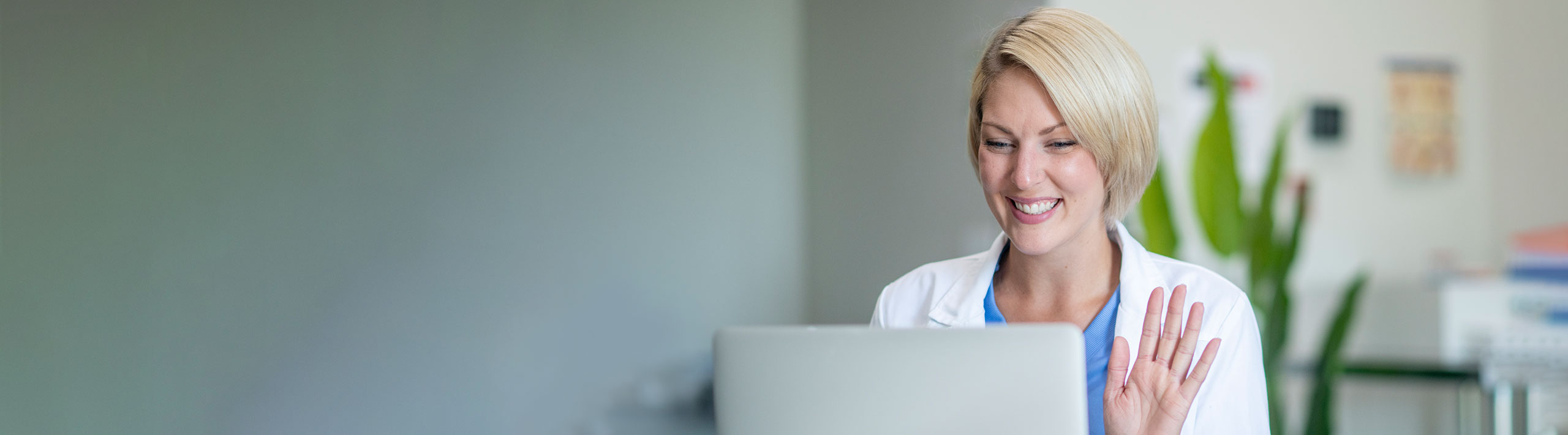 Medical Professional Waving at Computer | Virginia Mason Institute